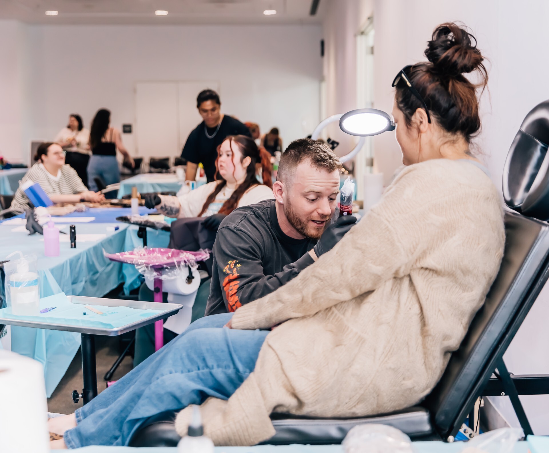 picture of tattoo artist tattooing a woman